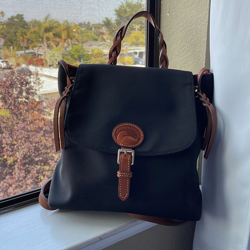 Dooney & Bourne Black canvas flap backpack with brown trim